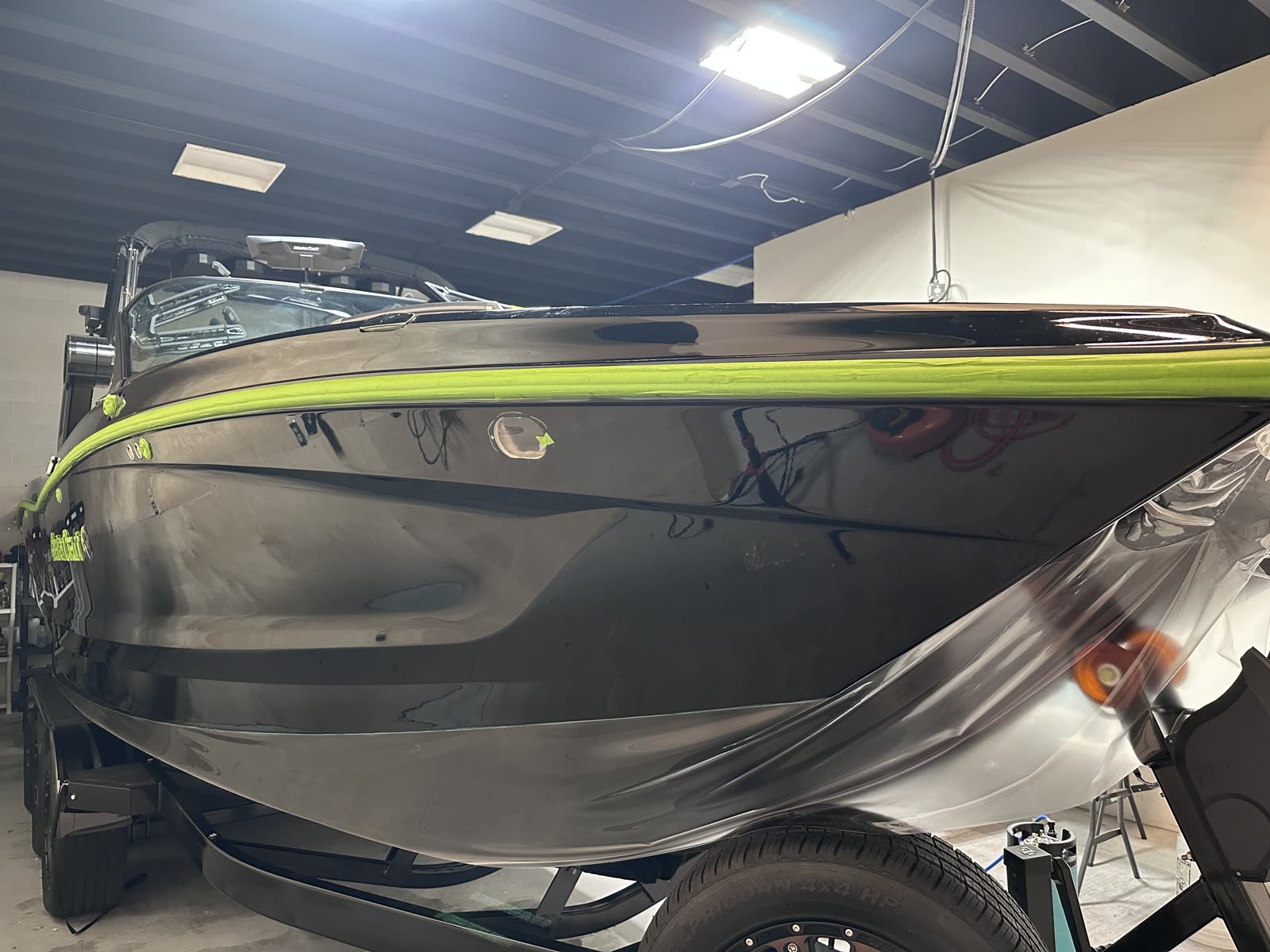 Yacht Armor marine protection film being installed on a hull side at our Bluffdale shop